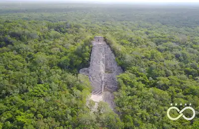 Aerial view of the Cobá pyramid surrounded by jungle